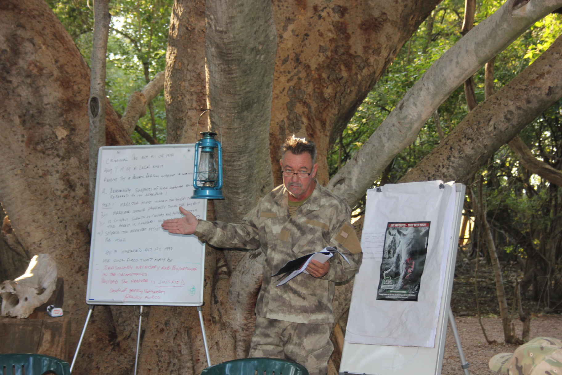 Les Brett briefing a class outdoors during anti-poaching instruction.