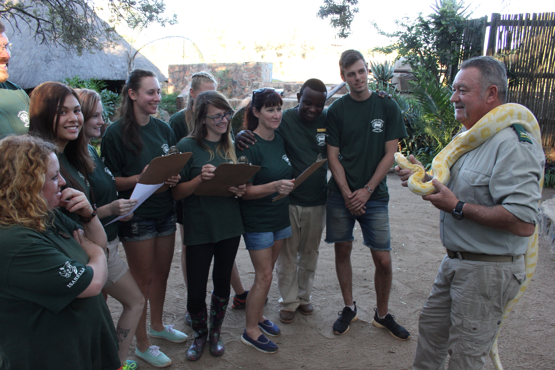 Les Brett introducing a python to a group of students at the lodge.