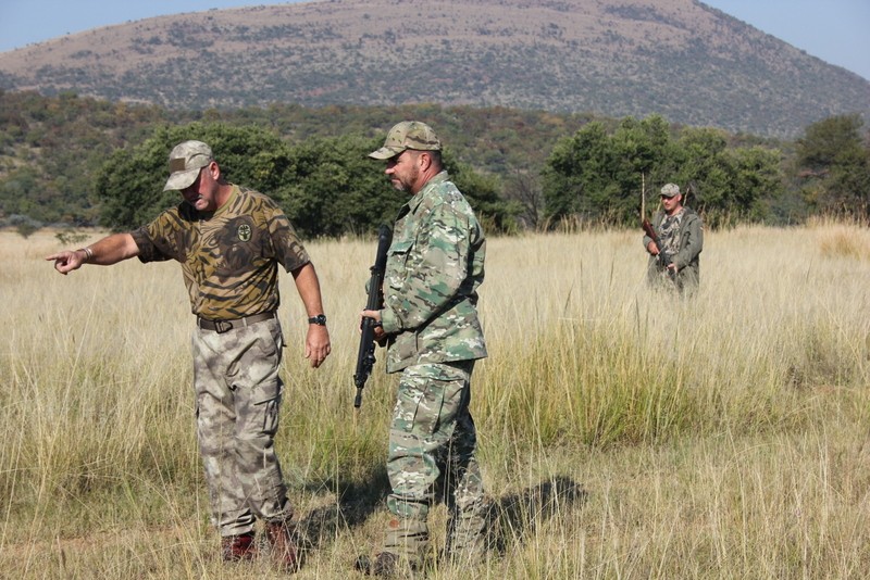 Field instruction on tactical movement and observation in open bushveld.